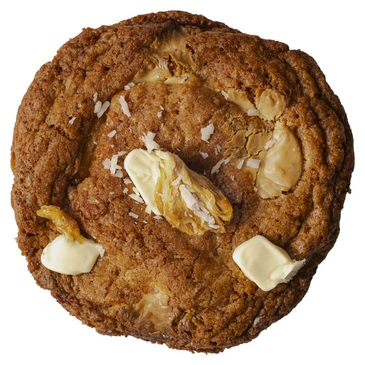 A real Pineapple, Coconut and White Chocolate cookie topped with dried pineapple, coconut flakes and white chocolate