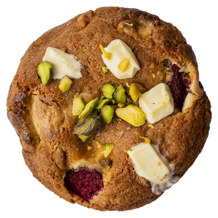 A real Raspberry, Pistachio and White Chocolate cookie topped with pistachios and white chocolate chunks